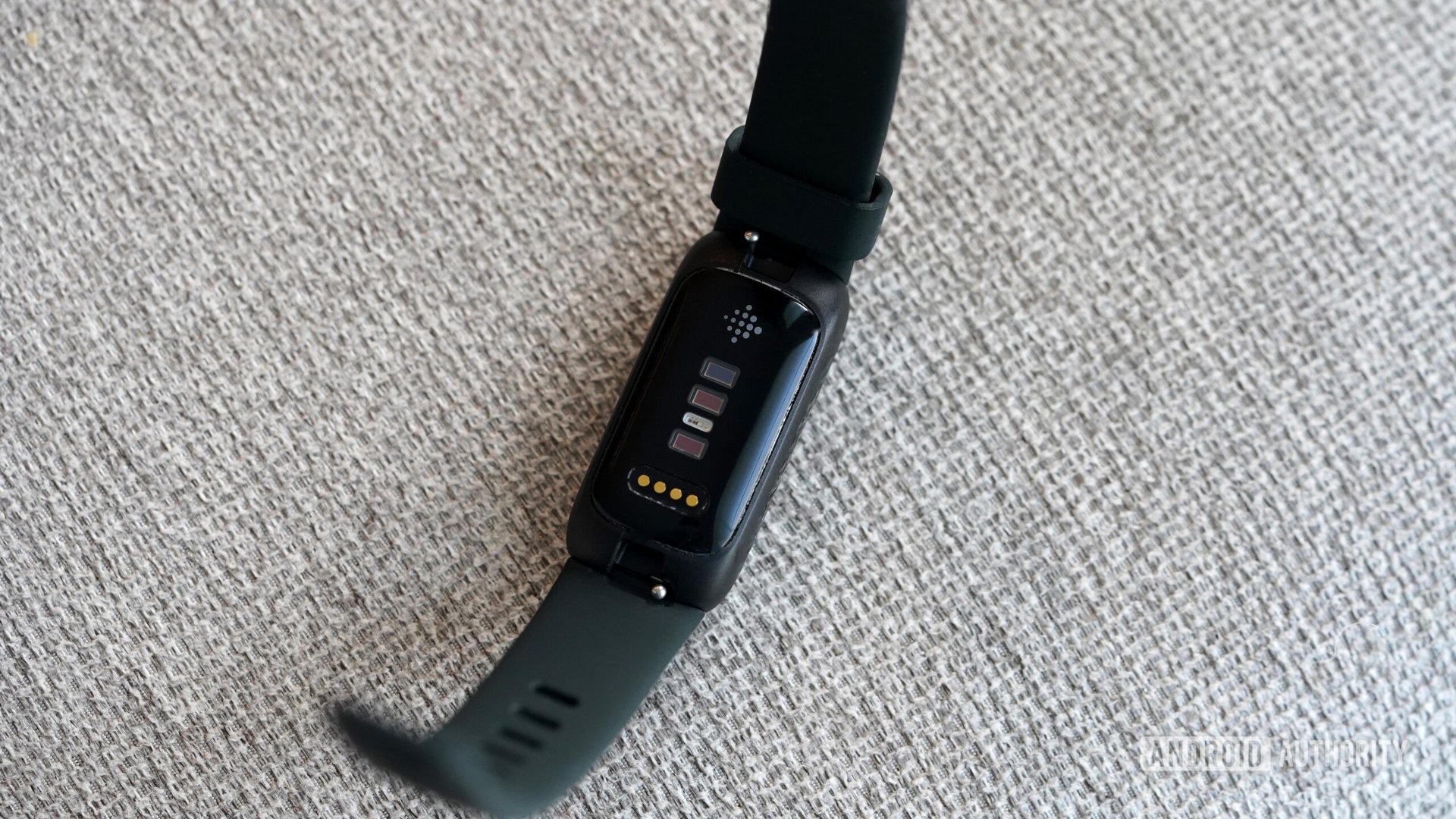 Fitbit Inspire 3 Sensors A Fitbit Inspire 3 rests face down displaying its sensors.