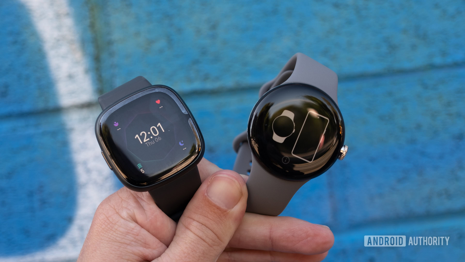 fitbit sense 2 vs google pixel watch held below fitbit sense 2 vs google pixel watch held below
