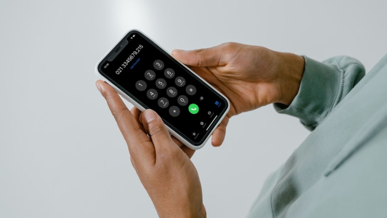 Man dialing a number on iPhone Man dialing a number on iPhone